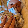 baby, blanket, blue_nails, closeup, comfort, cozy, cute, hand, hat, indoor, infant, nails, newborn, person, resting, skin, sleepy, soft_texture, striped_clothing, warm