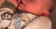 Elias is registered to the contest to win money with this photo: baby, sleeping, blanket, soft, newborn, infant, clothing, person, cute, peaceful, smile, closeup, hand, cozy, indoor, portrait, face, rest, comfort, newborn_clothes
