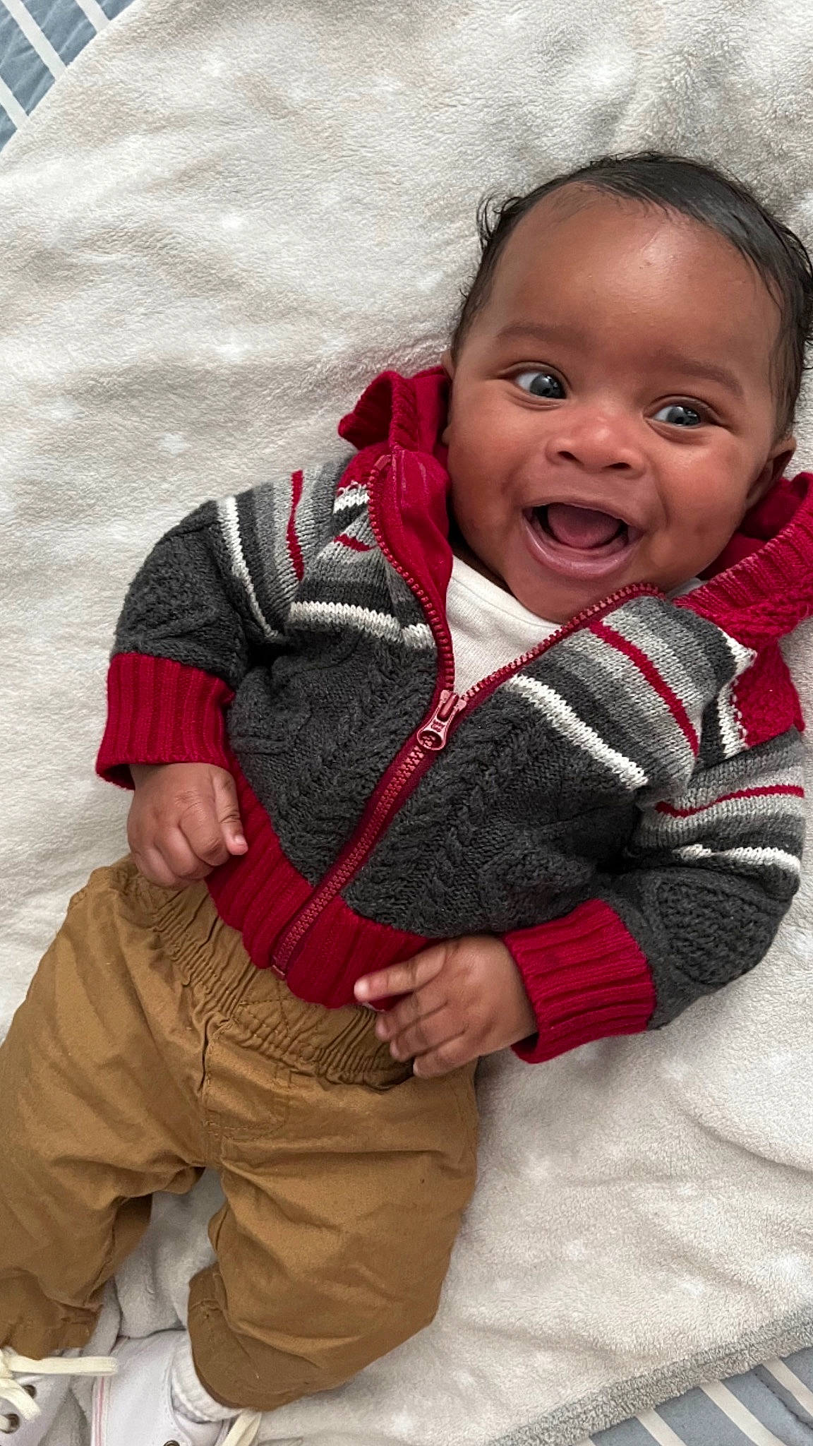 Jesiah is registered to the contest to win money with this photo: baby, baby_products, baby_toddler_clothing, cheek, child, comfort, eye, flash_photography, gesture, happy, human_body, jacket, nose, outerwear, person, sitting, skin, sleeve, smile, toddler