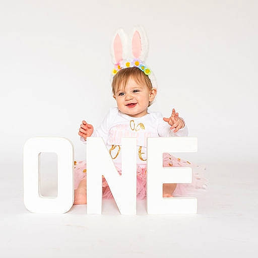 Elsie is registered to the contest to win money with this photo: art, baby, baby_toddler_clothing, brand, child, circle, costume_hat, crown, fashion_accessory, font, happy, headpiece, joy, party_supply, peach, person, product, rectangle, room, sleeve
