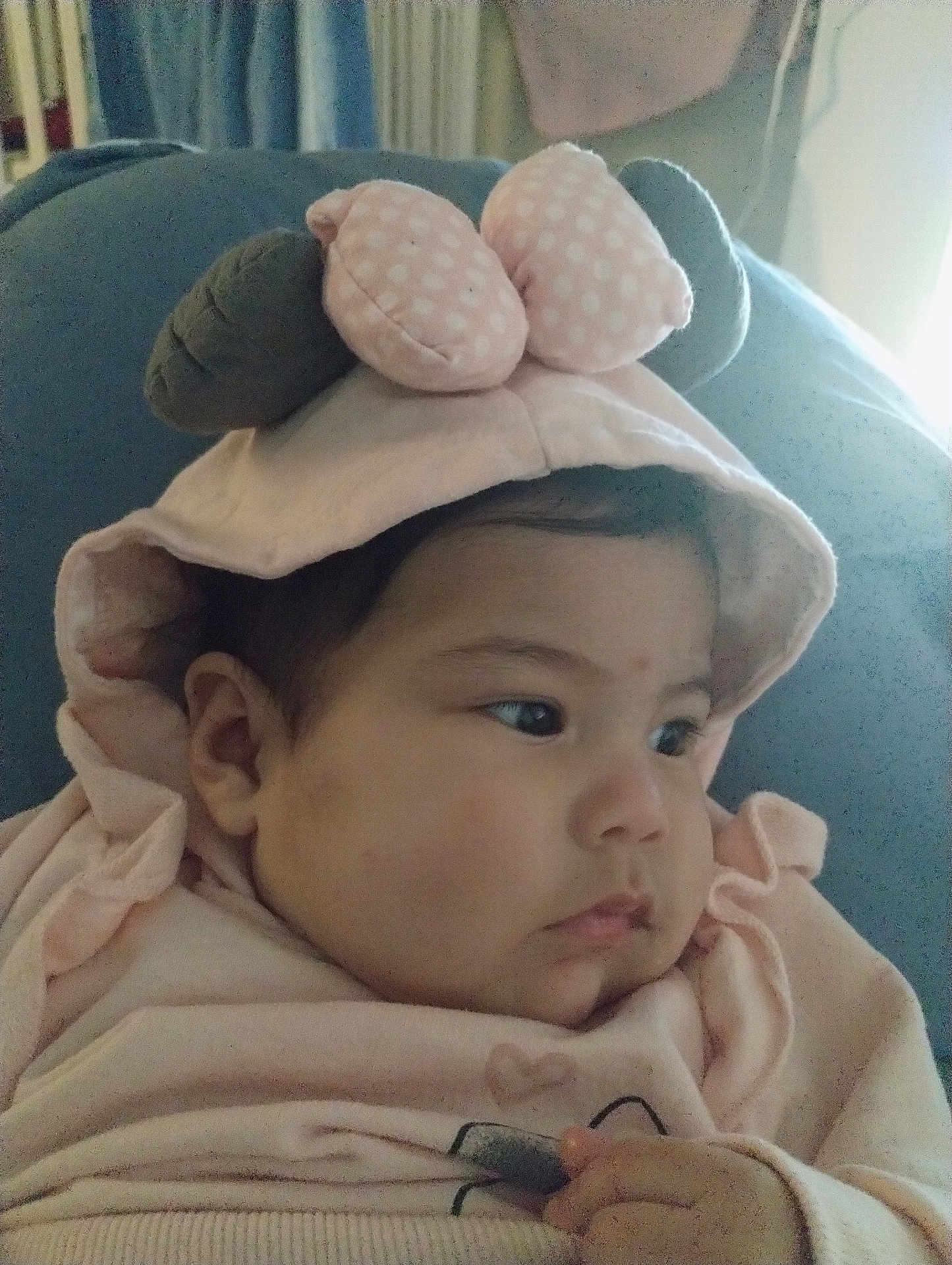 Aylany González is registered to the contest to win money with this photo: baby, infant, child, hood, polka_dot, pink_clothing, face, cheek, eyes, hand, sweater, soft_toy, couch, indoor, close_up, portrait, calm, fabric, curtain, looking_right