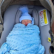 Noah is registered to the contest to win money with this photo: baby, blanket, blue, car_seat, child, clothing, cozy, cute, face, hat, infant, nap, outdoor, person, pom_pom, resting, sleeping, soft, warm, wrapped