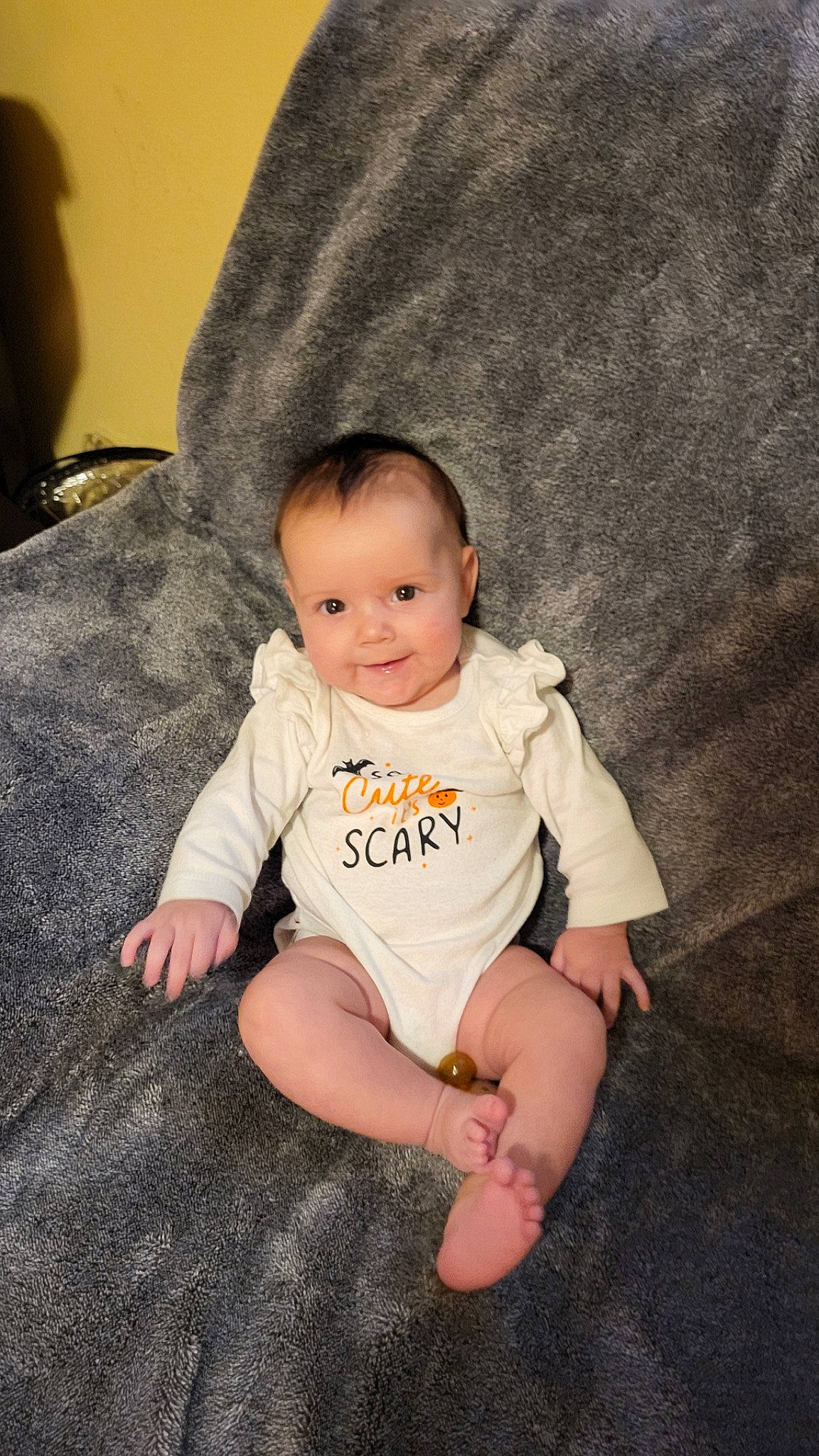 Aria is registered to the contest to win money with this photo: baby, baby_toddler_clothing, cheek, child, comfort, finger, flash_photography, floor, flooring, foot, grass, happy, human_leg, joy, person, sitting, skin, sleeve, smile, t_shirt