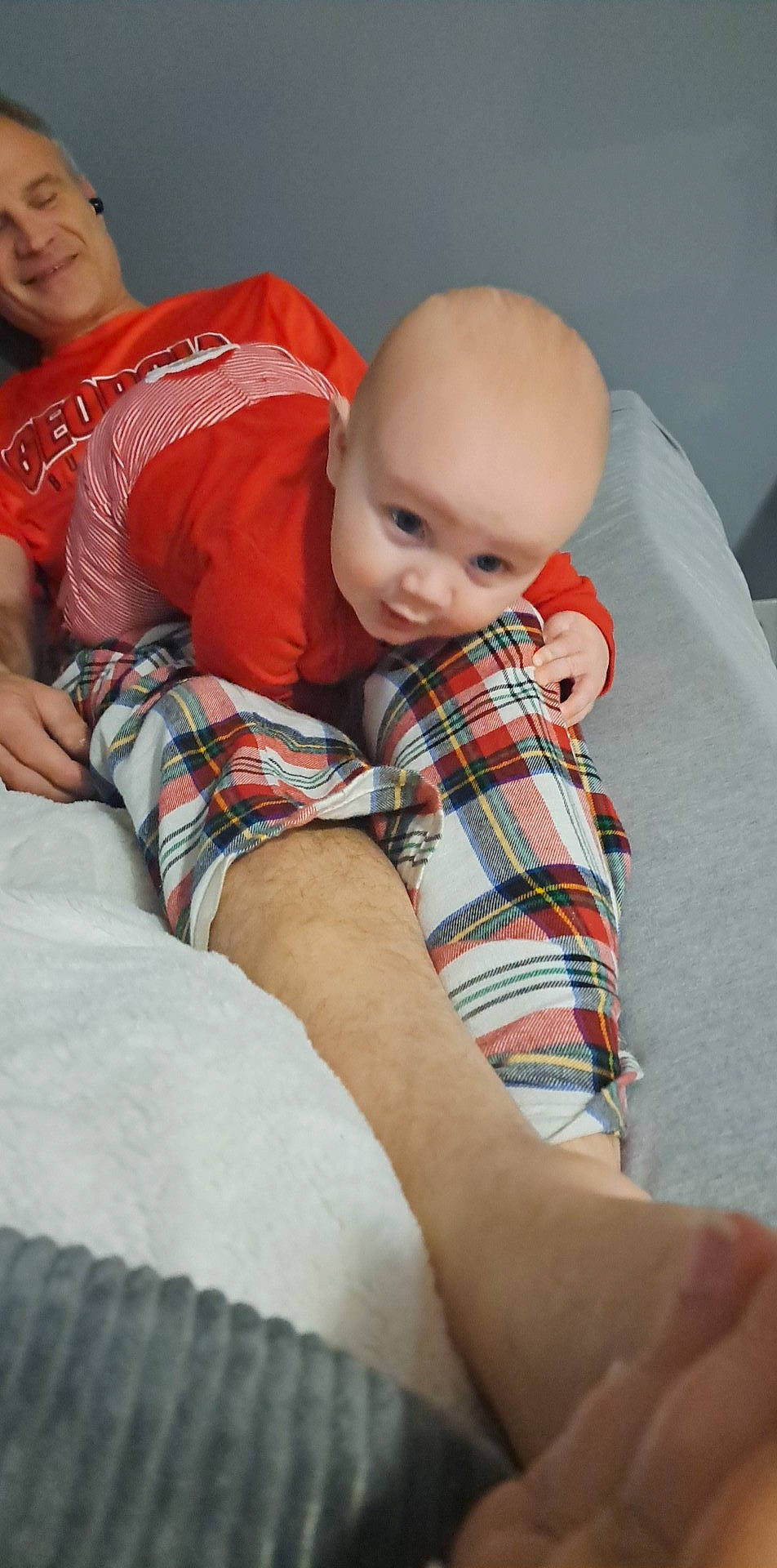 Jaxon is registered to the contest to win money with this photo: baby, comfort, elbow, finger, human_body, joint, joy, knee, lap, leg, mouth, pattern, person, plaid, shoulder, sleeve, t_shirt, tartan, textile, thigh