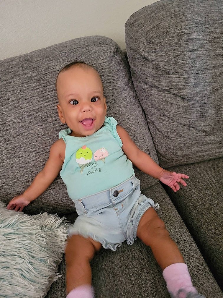 Laylah joined the competition — help win amazing prizes! baby, baby_toddler_clothing, cheek, child, comfort, couch, face, finger, happy, iris, leg, person, pink, skin, sleeve, smile, t_shirt, textile, thigh, toddler