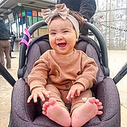 Salome joined the competition — help win amazing prizes! baby, child, smiling, headband, car_seat, outdoor, happy, barefoot, cute, infant, clothing, person, seat, expression, joy, portrait, hands, feet, closeup, casual