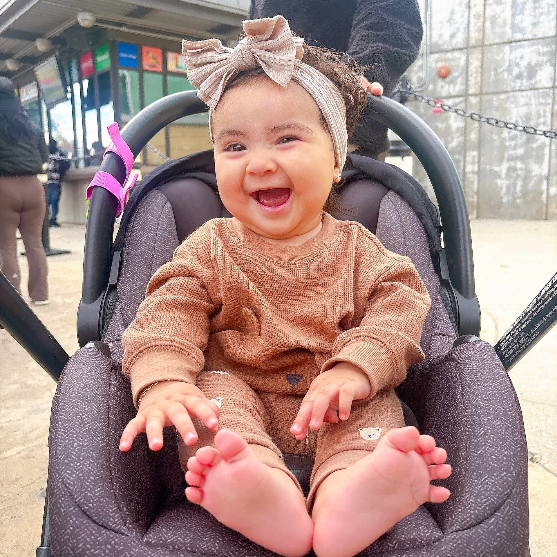 Salome joined the competition — help win amazing prizes! baby, child, smiling, headband, car_seat, outdoor, happy, barefoot, cute, infant, clothing, person, seat, expression, joy, portrait, hands, feet, closeup, casual