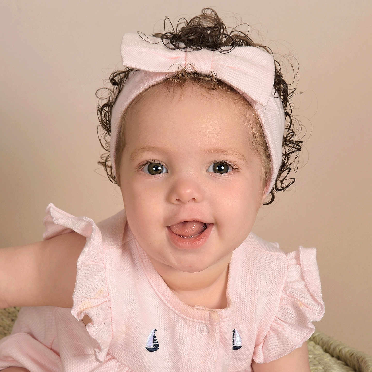 Lillyann is registered to the contest to win money with this photo: accessories, baby, babylaughing, bodypart, clothing, dress, face, finger, hand, happy, head, headband, laughing, mouth, newborn, person, photography, portrait, smile, teeth