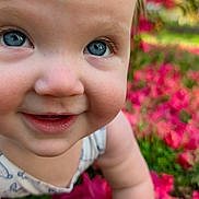 Lunaria is registered to the contest to win money with this photo: baby, child, blue_eyes, bow, crawling, flowers, pink_flowers, grass, outdoor, nature, happy, cute, face, skin, headwear, smiling, closeup, person, infant, sunlight