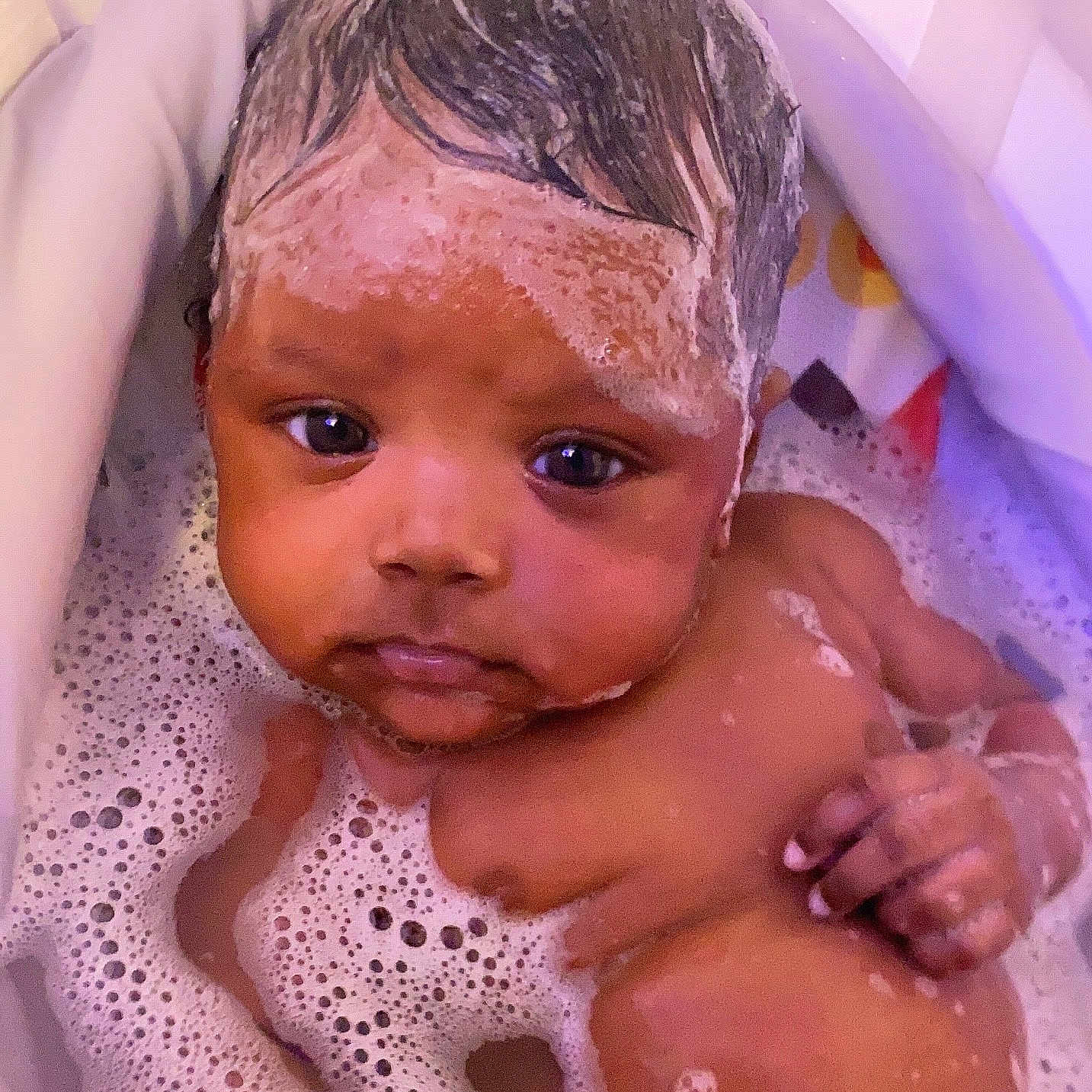 Riley is registered to the contest to win money with this photo: baby, back, bathing, bathtub, bodypart, bubble, face, finger, foam, hand, head, newborn, person, photography, portrait, tub, washing