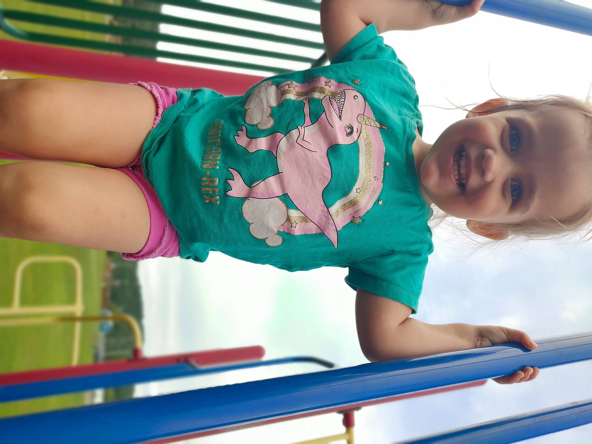 Lexi is registered to the contest to win money with this photo: blue, child, electric_blue, facial_expression, fun, green, happy, human_leg, joy, leisure, magenta, person, play, recreation, red, shorts, smile, snapshot, t_shirt, thigh
