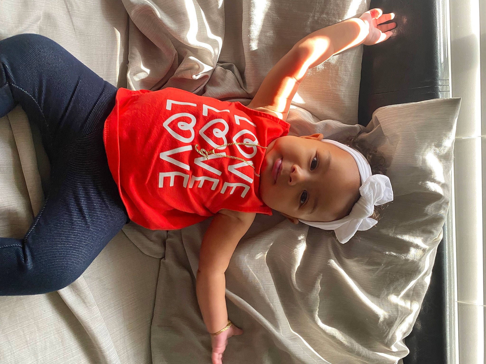 Jazmyn is registered to the contest to win money with this photo: baby, baby_carriage, baby_products, baby_toddler_clothing, carmine, child, comfort, elbow, happy, hat, human_leg, knee, person, room, sitting, sleeve, sportswear, t_shirt, thigh, toddler