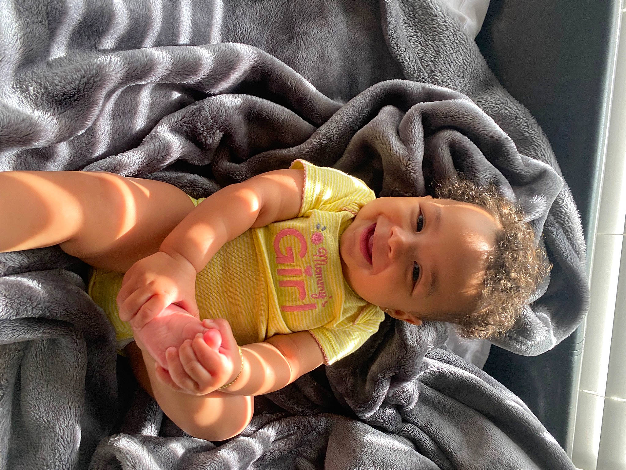 Jazmyn is registered to the contest to win money with this photo: baby, baby_carriage, baby_products, baby_sleeping, baby_toddler_clothing, cheek, child, comfort, fun, human_body, human_leg, joy, lap, linens, mouth, nail, person, sitting, skin, thumb
