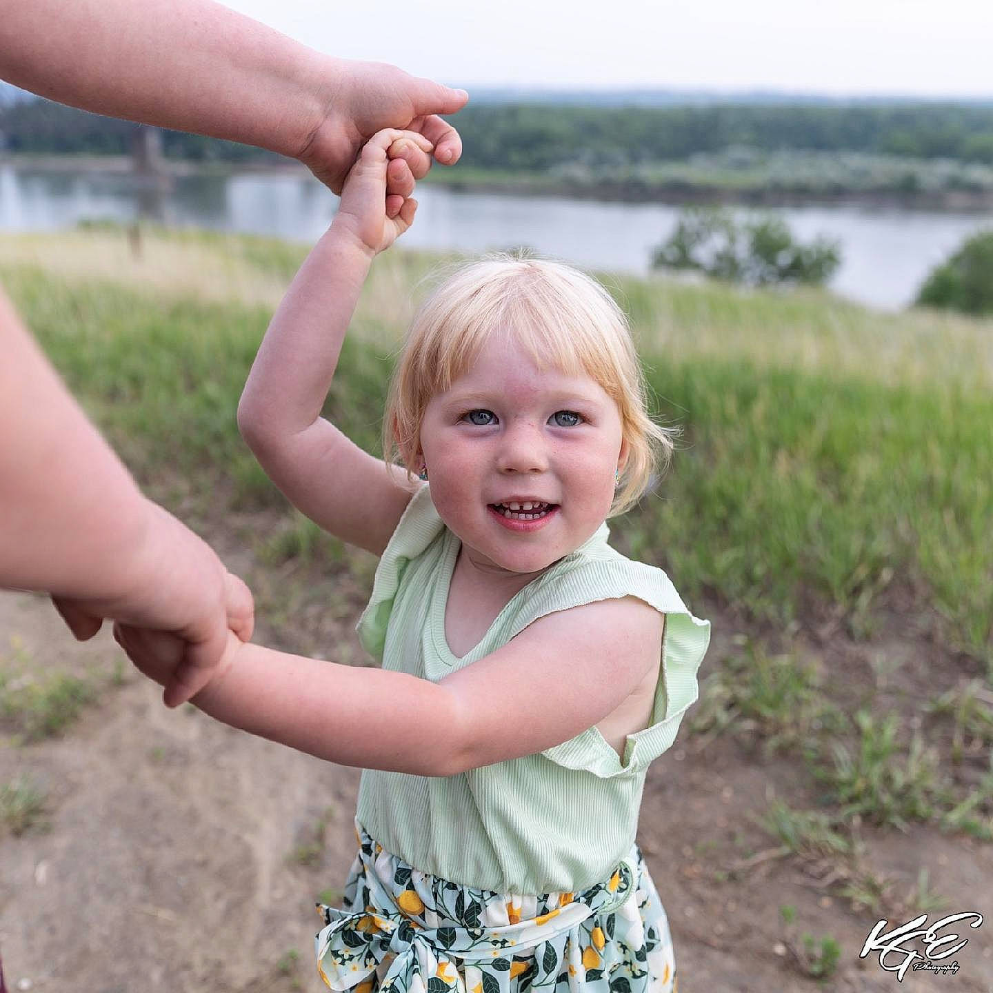 Clarissa joined the competition — help win amazing prizes! baby_toddler_clothing, child, face, facial_expression, finger, fun, gesture, grass, grass_family, hand, happy, head, joy, lake, leisure, people_in_nature, person, plant, smile, thumb