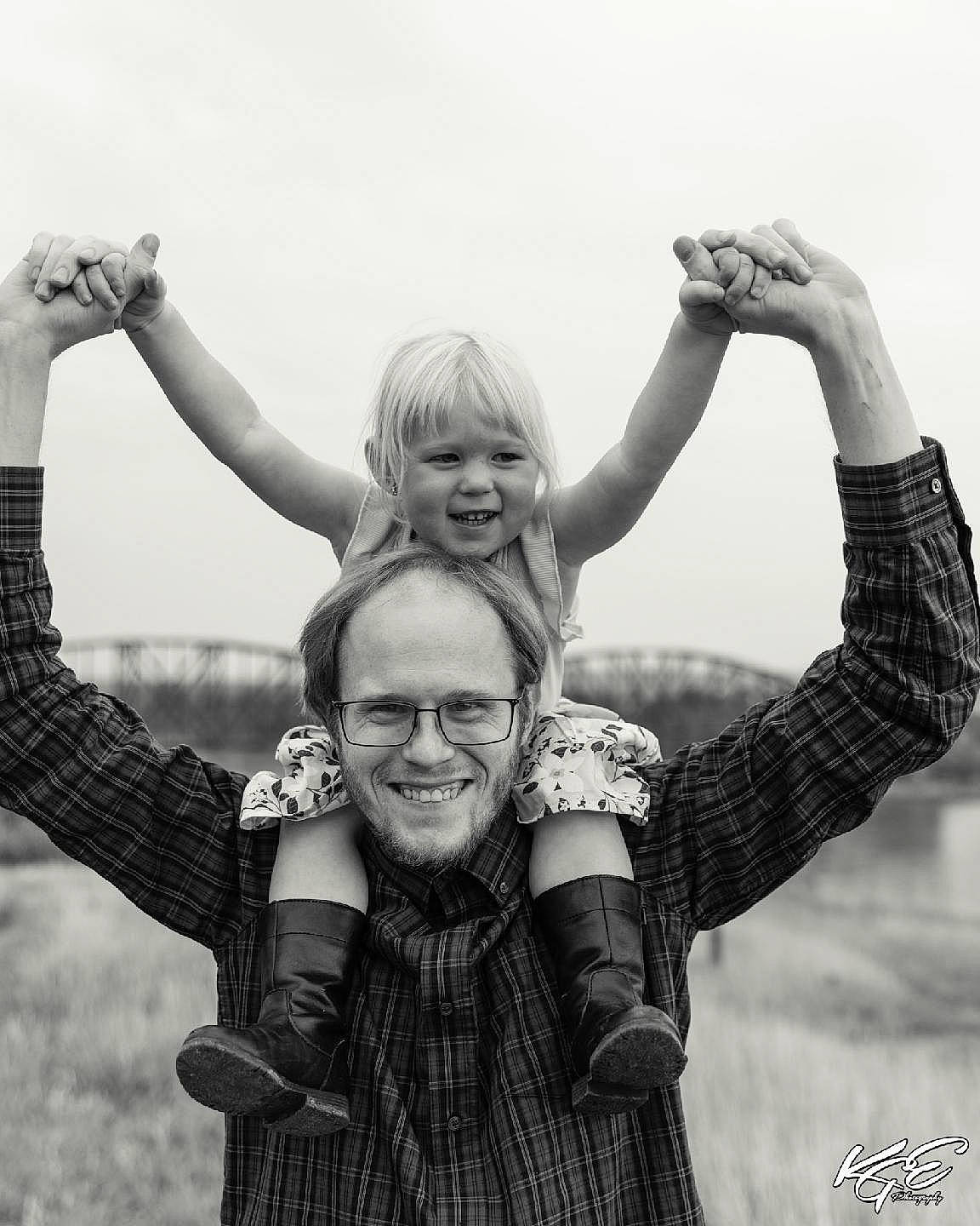 Clarissa is registered to the contest to win money with this photo: arm, black, black_and_white, cloud, finger, flash_photography, fun, gesture, grass, hairstyle, hand, happy, joy, people, people_in_nature, person, photograph, sky, smile, standing