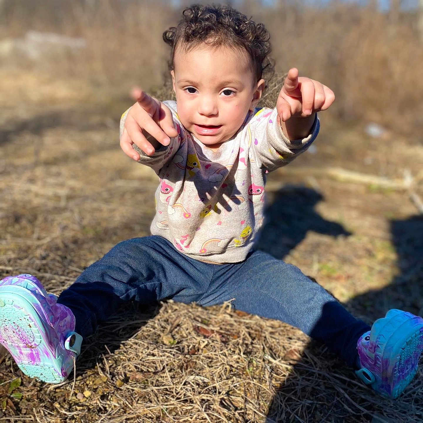 Leilani joined the competition — help win amazing prizes! bodypart, clothing, curlyhair, face, finger, footwear, grass, hair, hand, happy, head, jeans, pants, person, photography, plant, portrait, shoe, sitting, sneaker