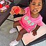 child, girl, watermelon, pink_clothing, sitting, chair, outdoor, food, fruit, summer, snack, shoes, socks, table, curly_hair, bow, smile, cute, furniture, happy