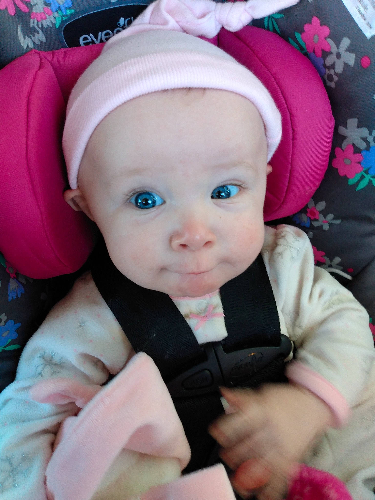 Arrow is registered to the contest to win money with this photo: baby, baby_carriage, baby_products, baby_safety, baby_toddler_clothing, cap, cheek, child, dress, facial_expression, fashion_accessory, happy, magenta, outerwear, person, pink, purple, skin, sleeve, textile