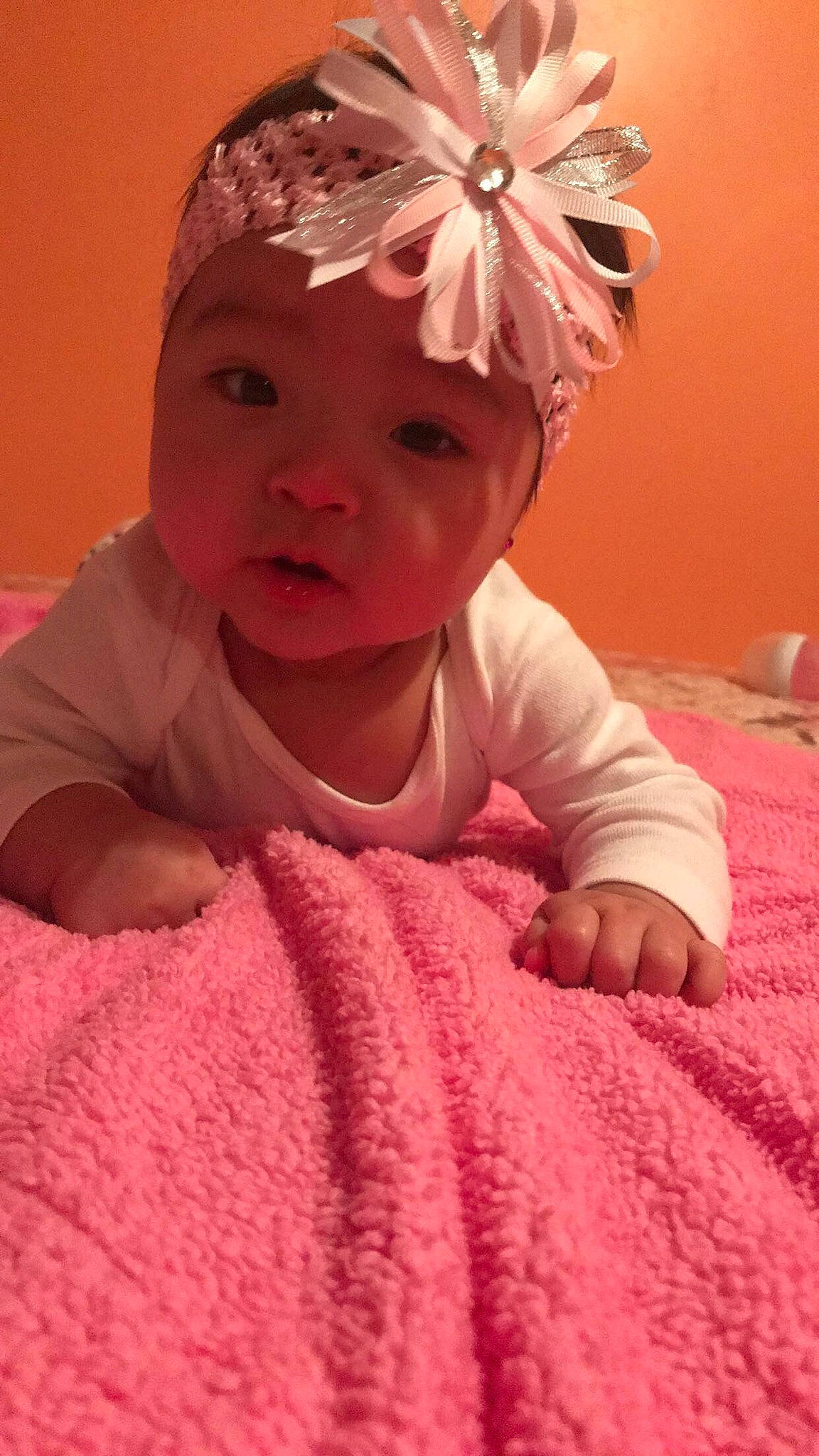 Ayana is registered to the contest to win money with this photo: baby, cheek, child, eye, hair_accessory, head, headband, headgear, headpiece, headwear, linens, nose, person, pink, skin, smile, toddler