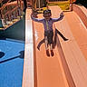 active, child, childhood, daytime, fun, girl, happy, leisure, outdoor, play, playground, recreation, slide, smile, sport, summer, sunlight, swimsuit, water, waterslide