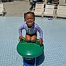 Romi is registered to the contest to win money with this photo: beads, braids, child, fun, girl, green_frog, happy, leisure, outdoor, play, pool, purple_clothing, recreation, smiling, splash, summer, sunny, swimsuit, water_feature, water_play