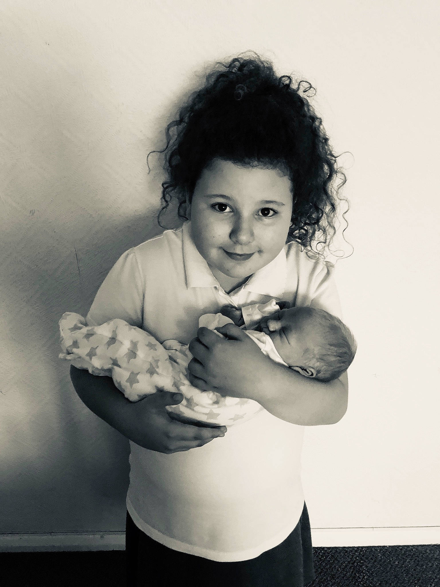 Caitlin is registered to the contest to win money with this photo: arm, black, black_and_white, black_hair, child, elbow, gesture, hand, joy, lip, monochrome, mouth, muscle, person, photograph, photography, portrait, shoulder, smile, style