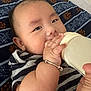 Kenton is registered to the contest to win money with this photo: baby, infant, feeding, bottle, bracelet, hand, face, striped_clothing, blanket, lying_down, cute, close_up, skin, peaceful, child, young, portrait, comfort, sleepwear, resting