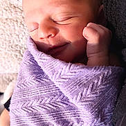 Cali joined the competition — help win amazing prizes! newborn, baby, sleeping, wrapped, blanket, lavender, soft, peaceful, smile, face, hand, cozy, texture, closeup, infant, skin, cute, resting, portrait, natural_light