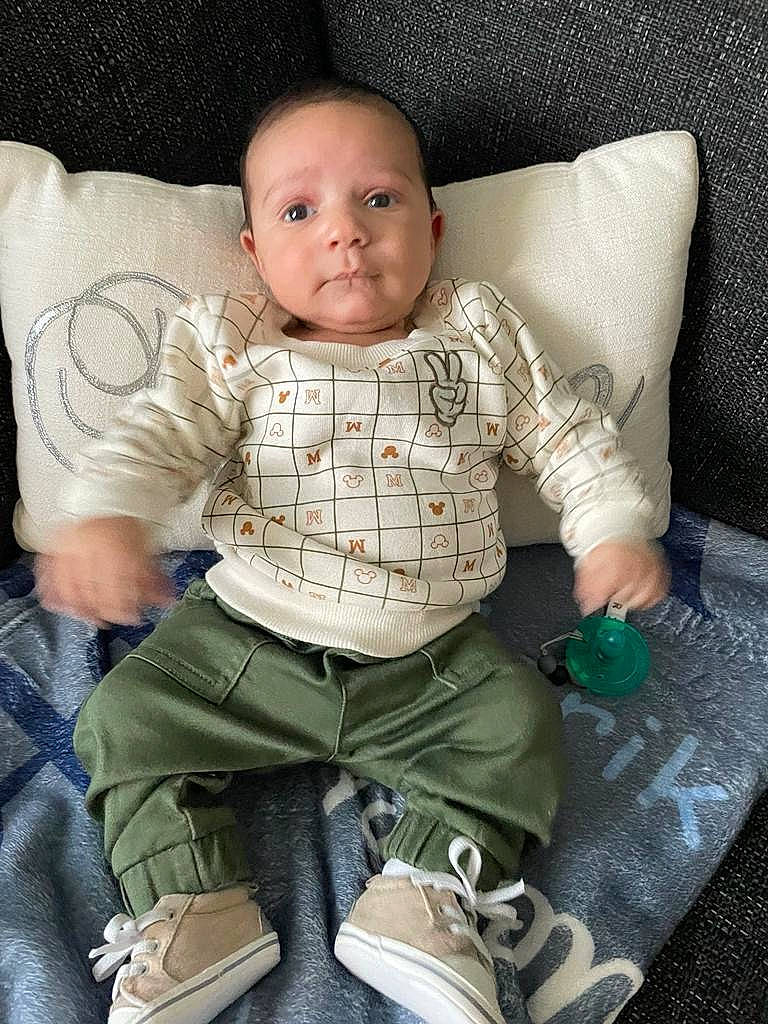 Adrik is registered to the contest to win money with this photo: baby, baby_toddler_clothing, cheek, child, comfort, eye, face, human_body, human_leg, knee, lap, leg, linens, person, sitting, skin, sleeve, sock, thigh, toddler