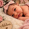 newborn, baby, infant, portrait, lying_down, wide_eyed, headband, pink, flowers, teddy_bear, blanket, fluffy, wooden_sign, name_plaque, heart, nursery, cozy, close_up, photography, adorable
