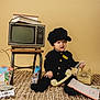 Liam joined the competition — help win amazing prizes! child, toddler, rotary_phone, telephone_receiver, vintage_tv, books, rug, hat, black_outfit, cassette_tape, magazines, retro, props, sitting, studio_shot, indoor, portrait, playful, smile, vintage_aesthetic
