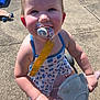 Ophelía is registered to the contest to win money with this photo: toddler, child, pacifier, dress, toy_scooter, outdoor, sunlight, concrete, skateboard, play, happy, smiling, person, summer, blue, yellow, star_pattern, hand, foot, garden_tools