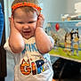 Ophelía is registered to the contest to win money with this photo: toddler, child, birthday, headband, orange, shirt, smile, playful, indoor, party, tablecloth, cartoon, celebration, happy, cute, clothing, person, face, hands, fun