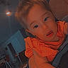 Alina joined the competition — help win amazing prizes! child, toddler, portrait, car_seat, indoors, vehicle, smiling, curious, face, eyes, hair, orange_shirt, seated, close_up, warm_lighting, photograph, home, background, safe, hello