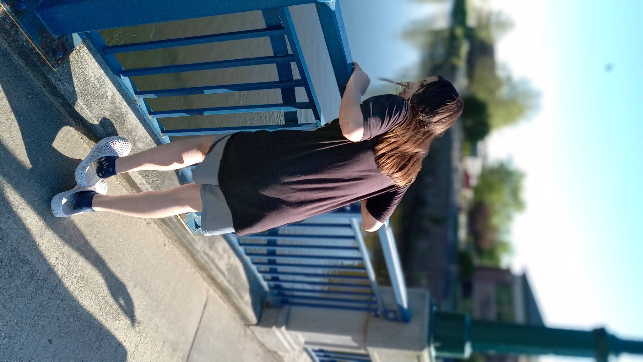 Alicia Gibson is registered to the contest to win money with this photo: dress, electric_blue, eyewear, foot, fun, human_leg, knee, leisure, person, shadow, sitting, sky, sportswear, stairs, sunglasses, sunlight, thigh, tree, waist