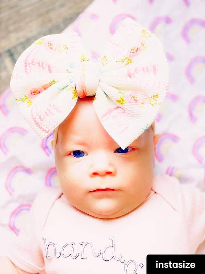 Arizona is registered to the contest to win money with this photo: baby, baby_toddler_clothing, cap, cheek, child, costume_hat, facial_expression, fashion_accessory, font, hair_accessory, happy, headband, headgear, headpiece, headwear, magenta, pattern, person, petal, pink