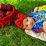 baby, child, grass, apples, basket, red_bow, headband, yellow_skirt, blue_top, costume, outdoor, nature, portrait, infant, cute, soft_blanket, greenery, colorful, young_child, lying_down
