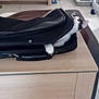 Harlem a rejoint le concours — aidez-le/la à gagner de superbes lots ! cat, suitcase, table, wooden_table, indoor, tile_floor, curious, pet, black_and_white_cat, partial_view, open_suitcase, furniture, living_room, door, cord, home, domestic, floor, compact, small_space