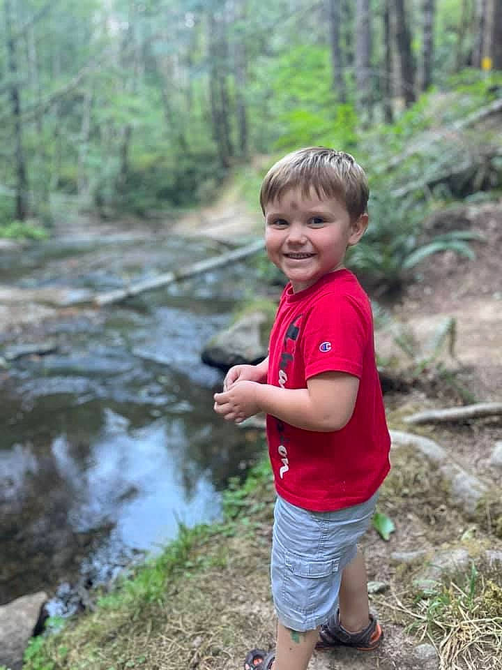 Westyn is registered to the contest to win money with this photo: forest, grass, joy, jungle, landscape, leisure, natural_landscape, people_in_nature, person, plant, recreation, riparian_zone, shorts, smile, stream, t_shirt, toddler, trail, tree, water