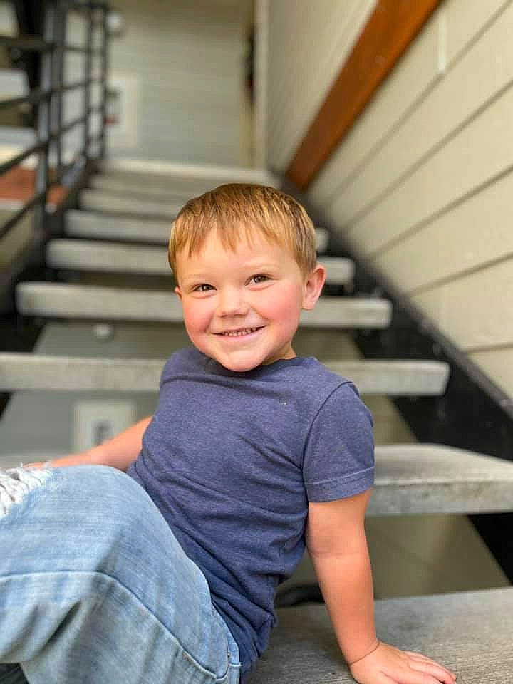 Westyn is registered to the contest to win money with this photo: child, chin, denim, eye, flash_photography, flooring, fun, hair, happy, human_body, human_leg, joy, leisure, person, sitting, skin, smile, standing, t_shirt, toddler