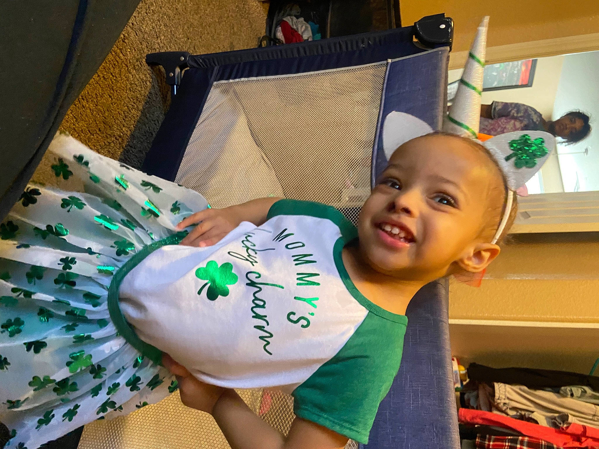 Avyana is registered to the contest to win money with this photo: baby, baby_toddler_clothing, child, happy, holiday, joy, linens, pattern, person, room, sitting, sleeve, smile, t_shirt, thigh, toddler