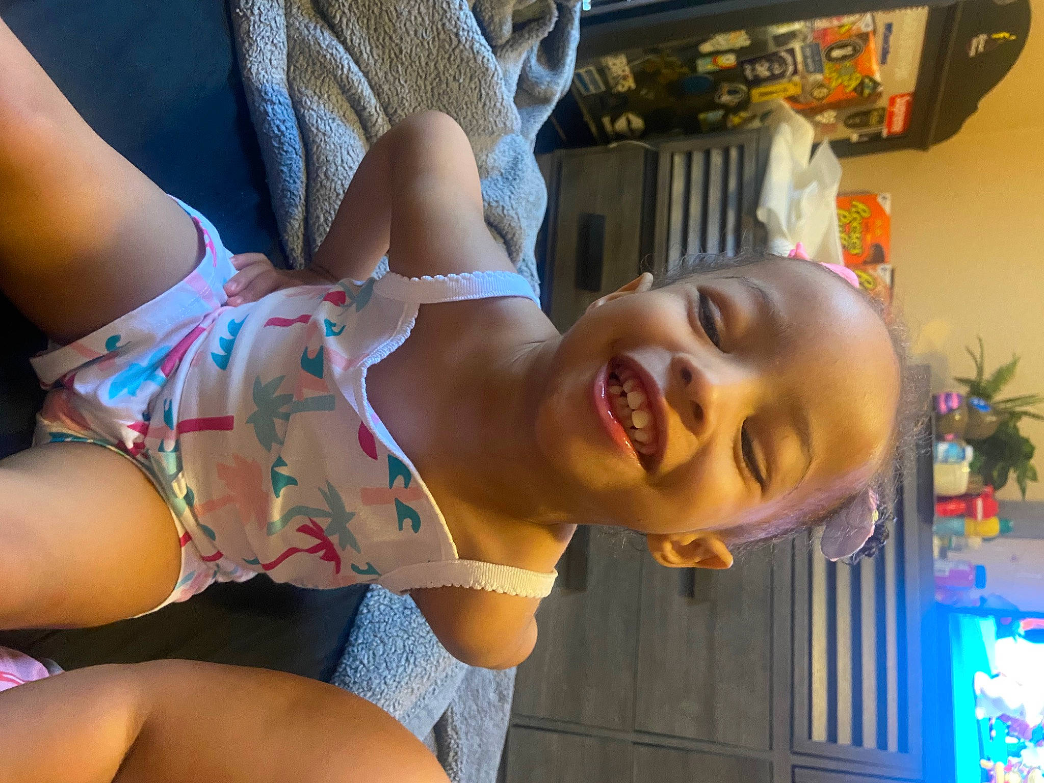 Avyana is registered to the contest to win money with this photo: black_hair, blue, brassiere, chest, facial_expression, finger, flowerpot, hairstyle, happy, houseplant, human_body, joy, leg, mouth, muscle, neck, person, shoulder, skin, smile