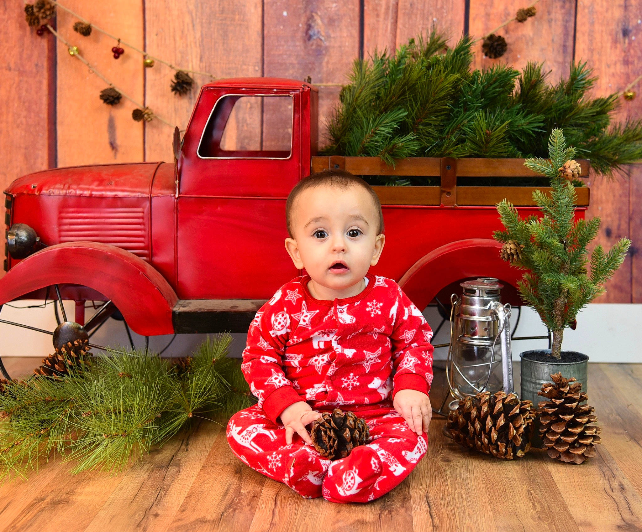 Nico is registered to the contest to win money with this photo: car, child, person, pine_family, plant, red, sitting, surprise, toddler, vehicle, vintage_car