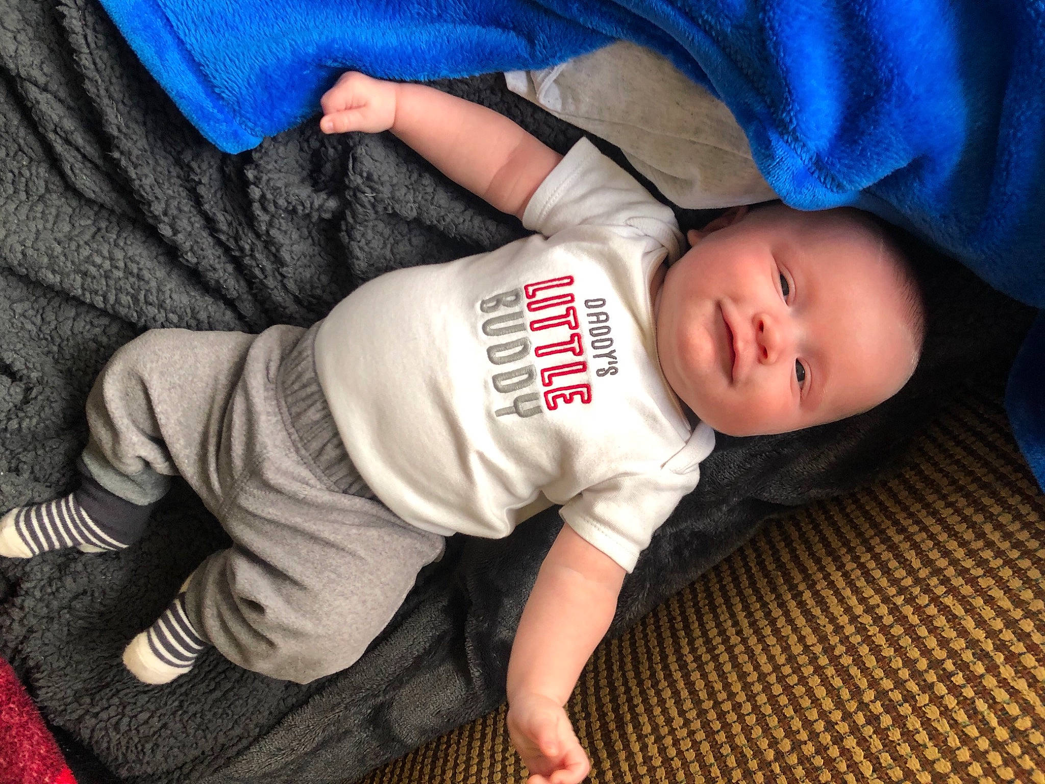 Brayden joined the competition — help win amazing prizes! baby, baby_toddler_clothing, blue, cheek, child, comfort, elbow, electric_blue, flash_photography, flooring, foot, grass, grey, human_body, pattern, person, skin, sleeve, t_shirt, toddler