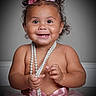baby, child, smile, pearls, pink, tutu, headband, curly_hair, portrait, happy, cute, toddler, jewelry, ribbon, sitting, studio, person, accessory, closeup, innocence