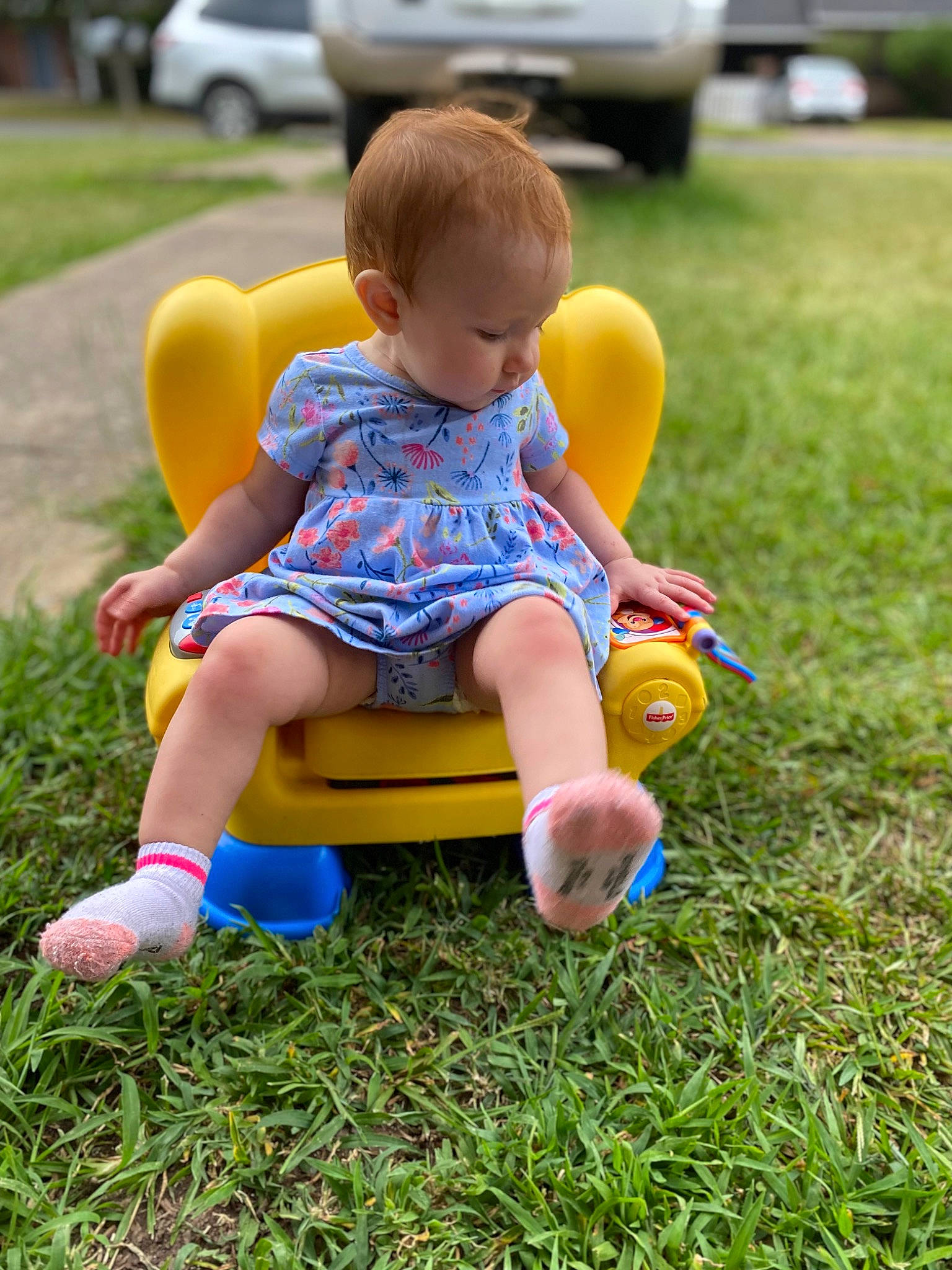 Charley is registered to the contest to win money with this photo: child, city, electric_blue, fun, grass, happy, lawn, leisure, people_in_nature, person, plant, recreation, shorts, sitting, sneakers, summer, t_shirt, toddler, toy, vehicle