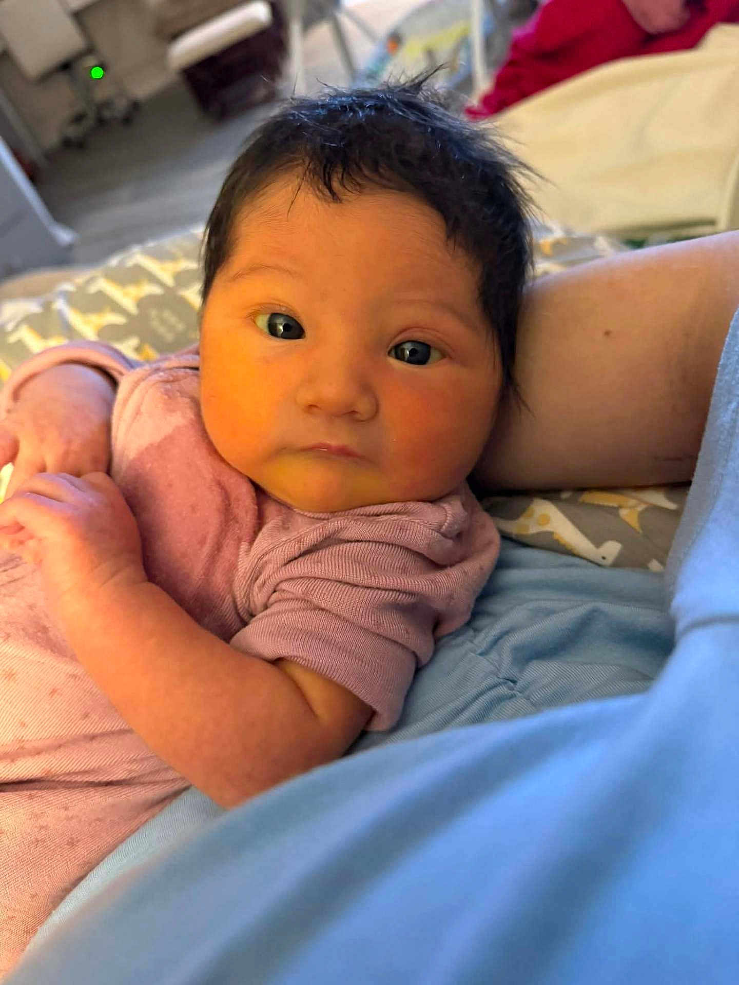 Autumn Lori is registered to the contest to win money with this photo: baby, infant, face, eyes, hair, skin, arm, clothing, blanket, bed, indoor, person, portrait, newborn, candid, soft_lighting, closeup, cute, resting, cozy