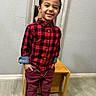 Anthony is registered to the contest to win money with this photo: child, boy, toddler, smiling, portrait, standing, indoors, plaid_shirt, red_shirt, black_shirt, burgundy_pants, fashion, shoes, wooden_table, hallway, mirror, wall, floor, home, happy