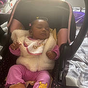 Janiyah is registered to the contest to win money with this photo: baby, sleeping, car_seat, pink_clothing, fur_vest, winnie_the_pooh, boots, indoor, window_blinds, bed, blanket, child, cute, infant, cozy, person, head, resting, adorable, toddler