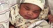 Janiyah joined the competition — help win amazing prizes! adorable, baby, blanket, child, clothing, cozy, cute, hat, infant, mickey_mouse, newborn, pattern, peaceful, person, pink_bow, resting, sleeping, soft, striped, wrapped